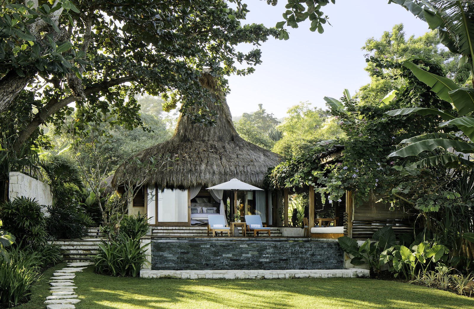Thatched villas above the surf coast at NIHI Sumba, Indonesia